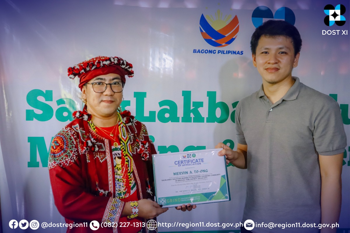 A member of Bagobo-Tagabawa tribe receiving a Certificate of Appreciation