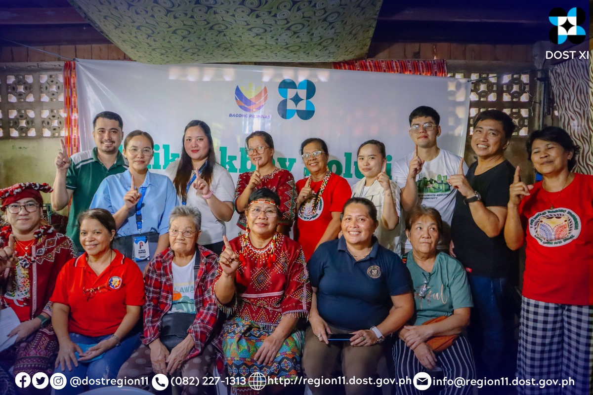 A group of people having the One DOST sign during a picture taking